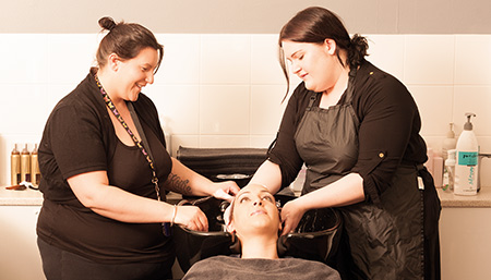 Two hairdressers with a client